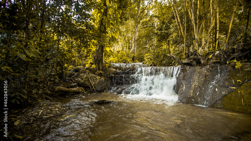 The natural background of waterfalls that blur the flow of water, with various tree species surrounded and boulders of various sizes, the beauty of the ecosystem and the jungles of forests. The natural background of waterfalls that blur the flow of water, with various tree species surrounded and boulders of various sizes, the beauty of the ecosystem and the jungles of forests.