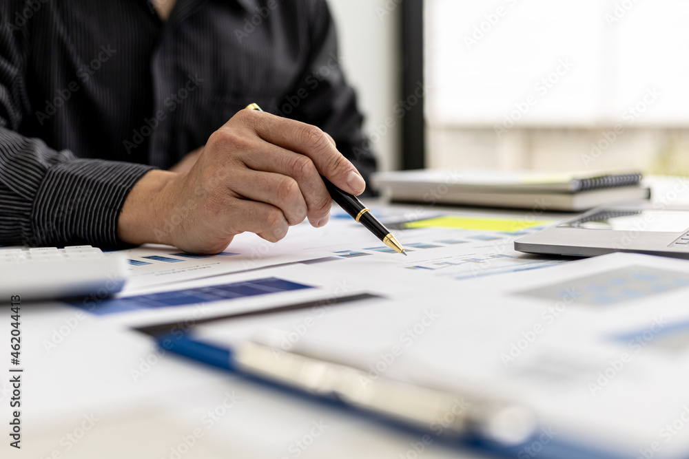 Business men are looking at the company's financial documents to analyze problems and find solutions before bringing the information to a meeting with a partner. Financial concept. Business men are looking at the company's financial documents to analyze problems and find solutions before bringing the information to a meeting with a partner. Financial concept.