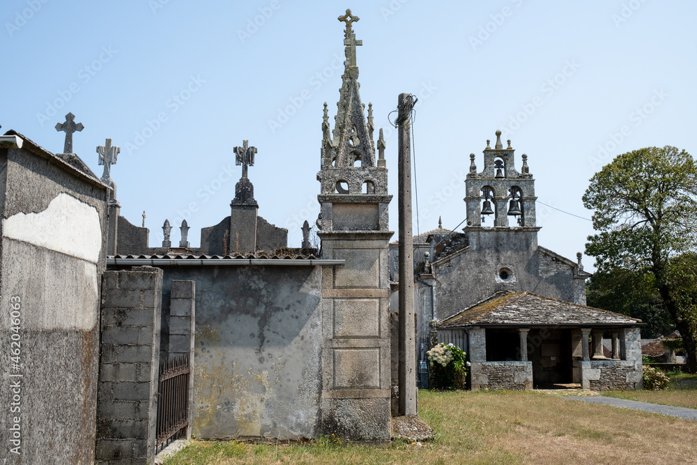 LUGO, SPAIN; AUGUST 23, 2021: Small gothic style cemetery next to churches in small town in northern Spain