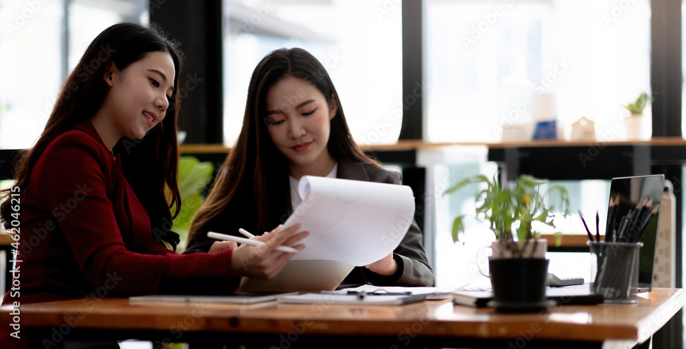 Focused young businesswoman signing agreement with skilled lawyer in eyeglasses. Concentrated financial advisor showing place for signature on paper contract document to male client Focused young businesswoman signing agreement with skilled lawyer in eyeglasses. Concentrated financial advisor showing place for signature on paper contract document to male client