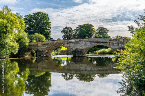 A view of an old medieval bridge over the River Ure on the outskirts of Ripon, Yorkshire, UK in summertime