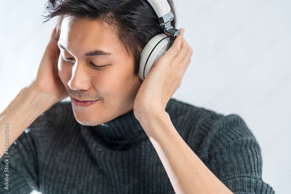 portrait studio music lyric concept yound smart asian artist wear sweater listen headphone enjoy music audio in dance with happiness mood positive movement eye close white background portrait studio music lyric concept yound smart asian artist wear sweater listen headphone enjoy music audio in dance with happiness mood positive movement eye close white background