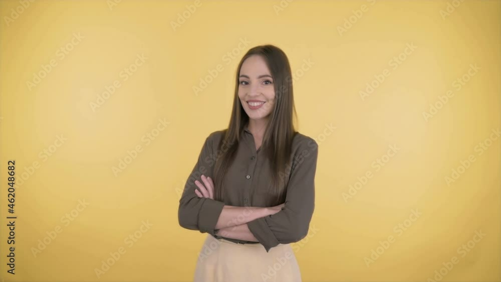 Business attractive woman 35 middle-aged years on an isolated yellow background in the studio. Business woman in business business suit confidently stands arms crossed. Business attractive woman 35 middle-aged years on an isolated yellow background in the studio. Business woman in business business suit confidently stands arms crossed.