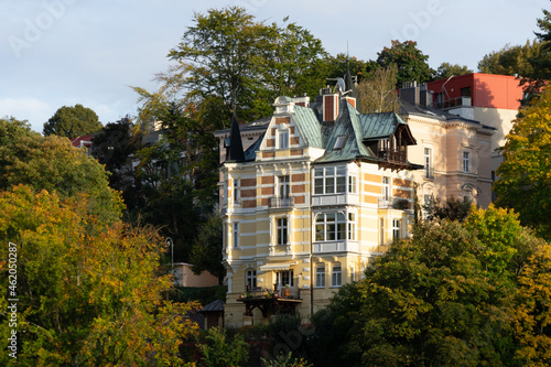 Slow Travel Europe: Karlovy Vary (Karlsbad) in Czech Republic - beautiful town house among autumn colored trees on central hill