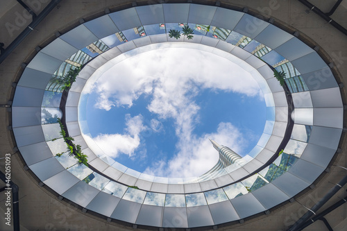 Milan, Italy - October 9, 2021: low angle view of Piazza Gae Aulenti in Milan, no people are visible. Cloudy blue sky is visible above. photo