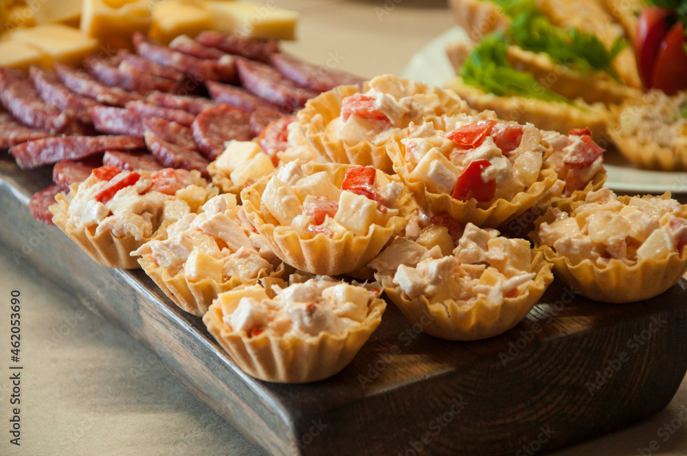 tartlets with vegetables. salad in plates. delicious delicacy on the table. food closeup tartlets with vegetables. salad in plates. delicious delicacy on the table. food closeup