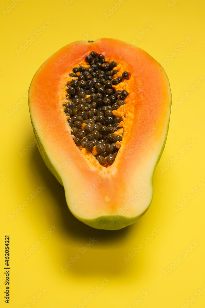 Papaya fruit on a yellow background. Tropical fruit. Papaya fruit on a yellow background. Tropical fruit.