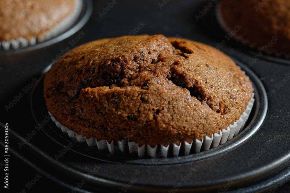 Fototapeta premium Close up of chocolate muffin in a baking pan