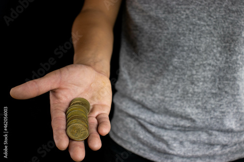 man with dollar coins on black background