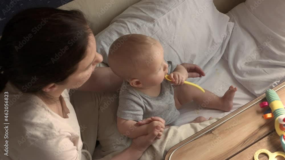 Mom and son by window in moving train, mother with little cute baby boy traveling by railway in train compartment. High quality 4k footage Mom and son by window in moving train, mother with little cute baby boy traveling by railway in train compartment. High quality 4k footage