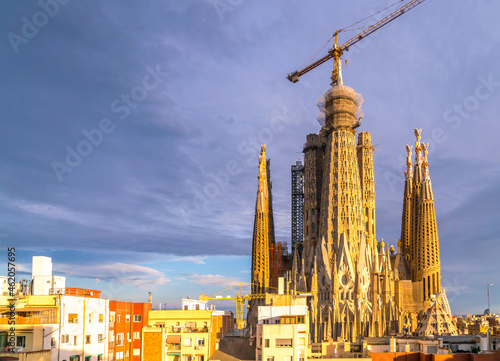 Wide Angle view of the Sagrada Familia during Sunset with Clouds in the Sky © porqueno