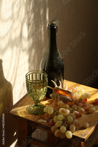 Still life with a glass of white wine on a wooden background