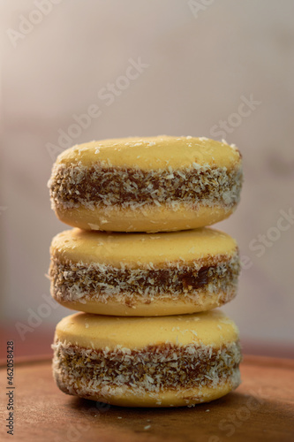 Traditional alfajores with dulce de leche on a wooden table. Argentinean gastronomy concept.