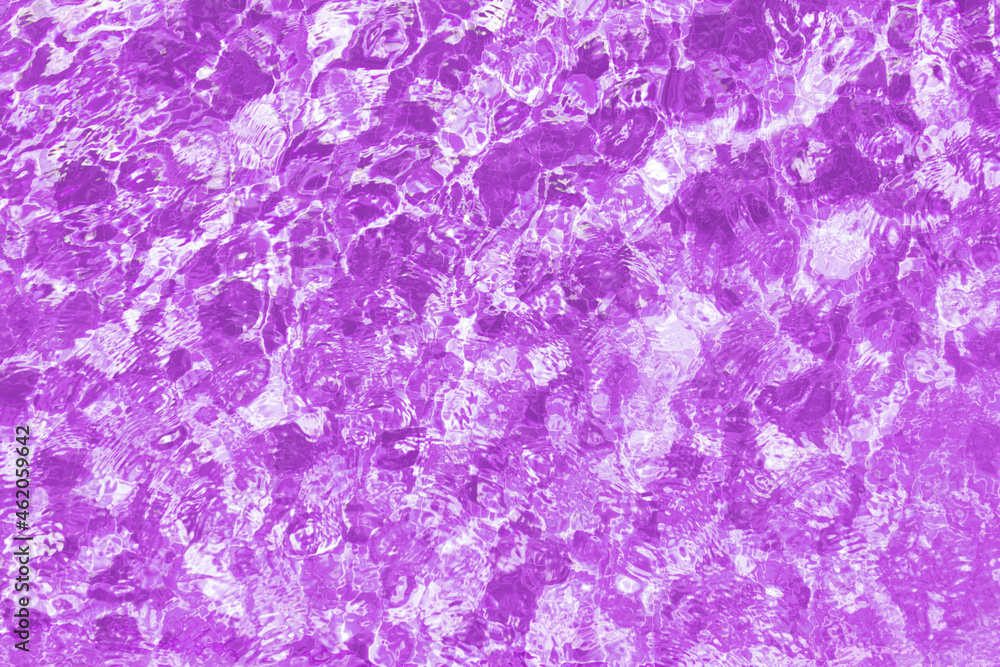 Splashes of purple water in the pool. Textured background. Top view, copy space.