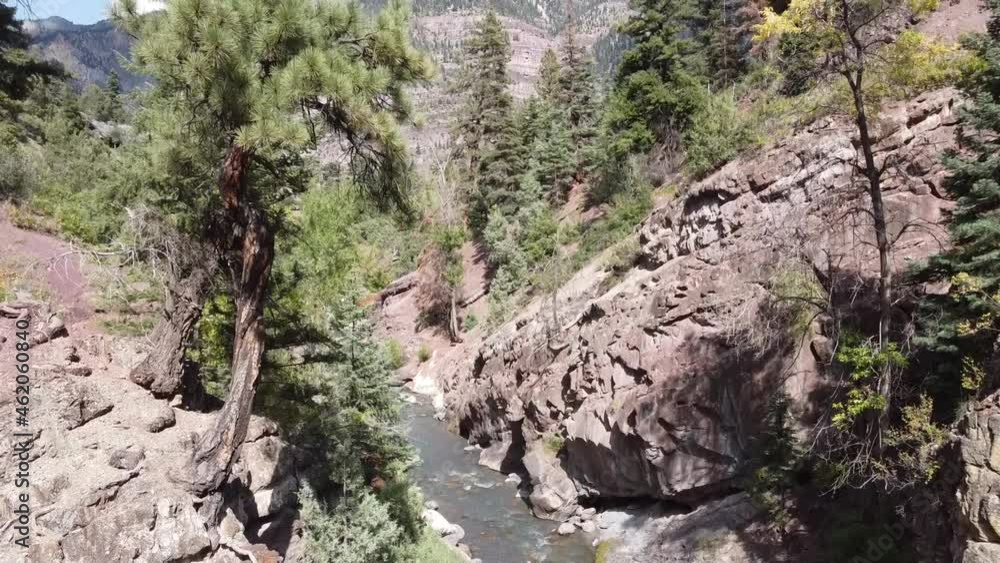 Aerial fly up from base of river to view of small mountain town Ouray, Colorado Aerial fly up from base of river to view of small mountain town Ouray, Colorado