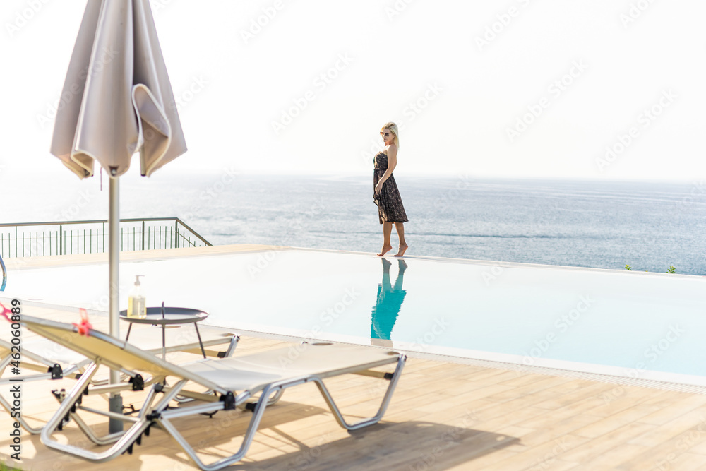 Beautiful woman resting near swimming pool Beautiful woman resting near swimming pool