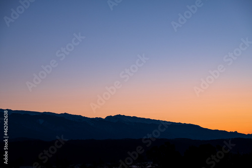 gradient sky in the mountains of pink color. mountain peaks in the snow