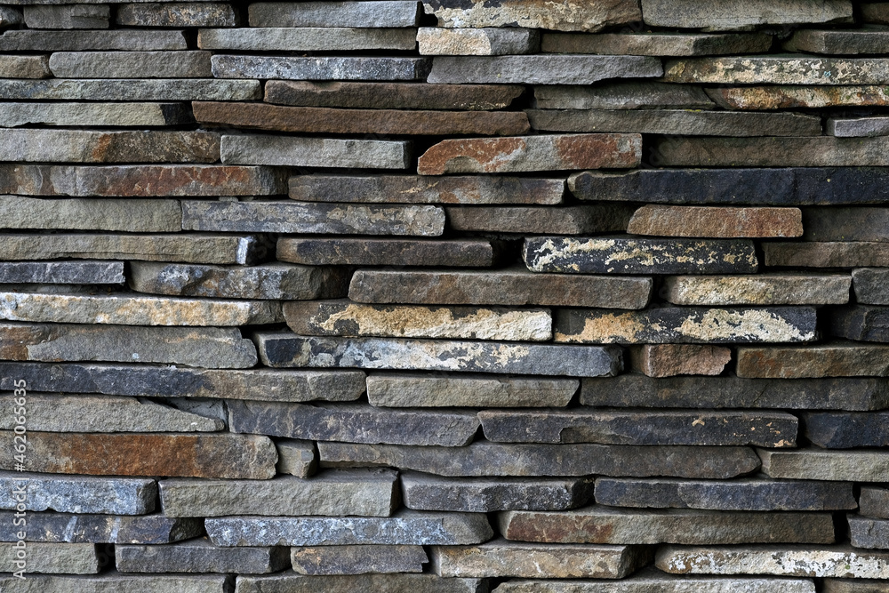 Dark brown rough stone wall. Brick wall stack background. Rock wall surface. Stony texture. Abstract pattern of brown stone texture. Pattern of decorative tile. Rough granite surface. Dark brown rough stone wall. Brick wall stack background. Rock wall surface. Stony texture. Abstract pattern of brown stone texture. Pattern of decorative tile. Rough granite surface.