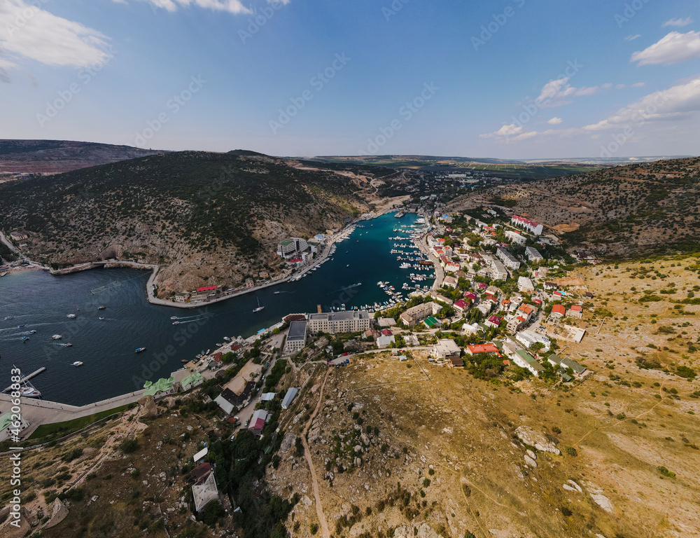 Bird's-eye view of the ancient quiet harbor in the mountain bay of the Black Sea.