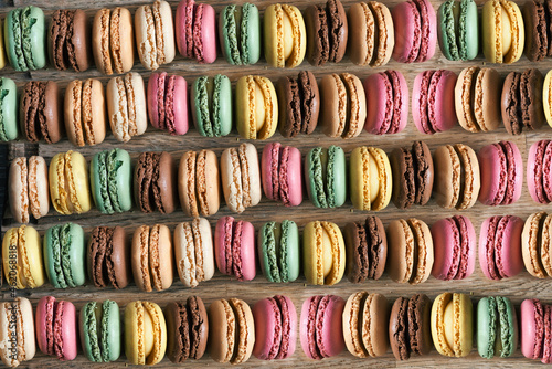 Colorful macarons background aerial or top view on wooden table