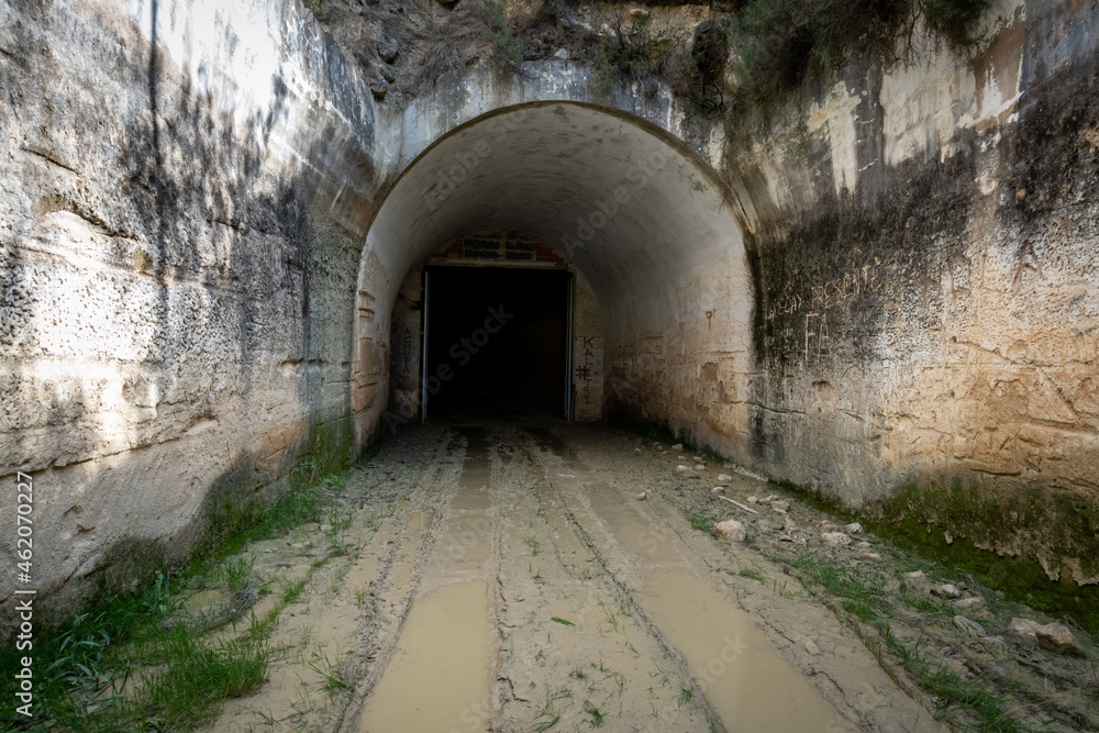 Long and dark tunnel, with a lot of humidity and mud on the ground