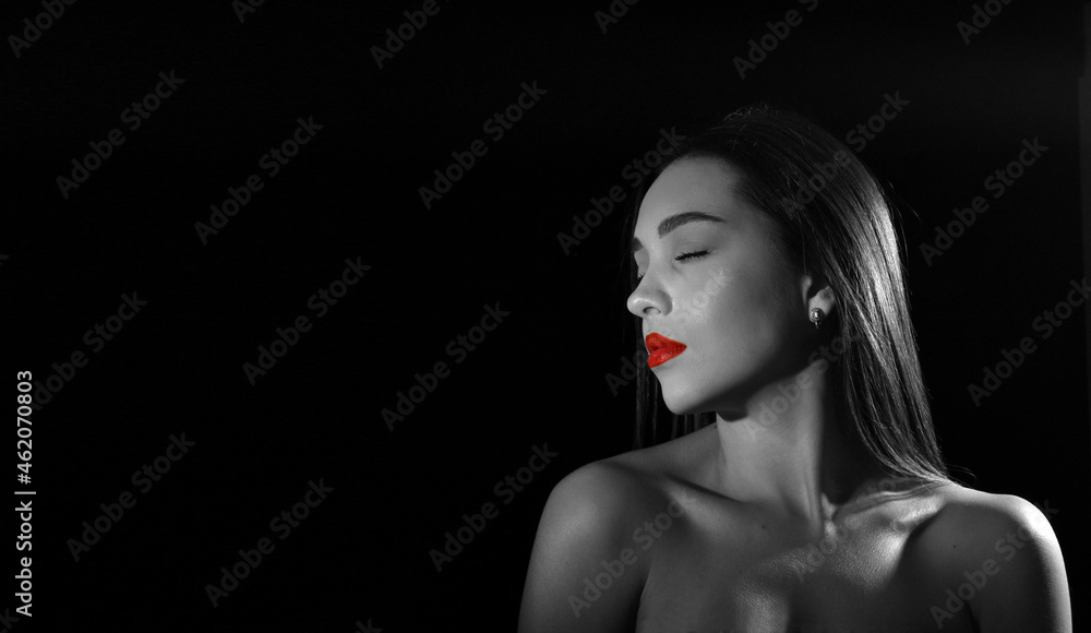 portrait of a beautiful young woman with closed eyes and bare shoulders, isolated on black background with space for text.monochrome portrait of a beautiful young woman with closed eyes and bare shoulders, isolated on black background with space for text.monochrome