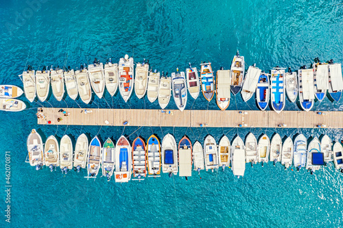 Aerial view of the boats and yachts on sea coast with transparent blue water. Paleokastritsa, Corfu Island, Greece