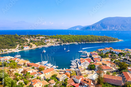 Aerial drone view of Fiscardo village port with luxury boats and yachts on Kefalonia island, Greece.