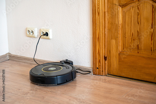 robot vacuum cleaner return to charging at dock in clean room floor