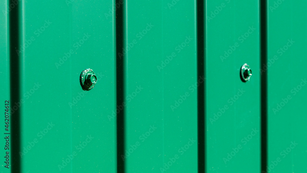 Obraz premium Outdoor garden fence building, new installed base frame with supports for a new metal fence in perspective against the background trees and green grass on summer day