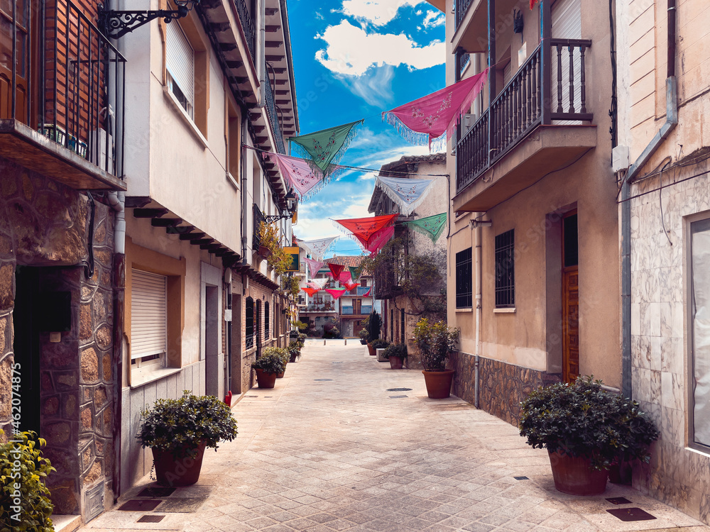 Spanish village street in the province of Avila decorated with shawls. Copy space.