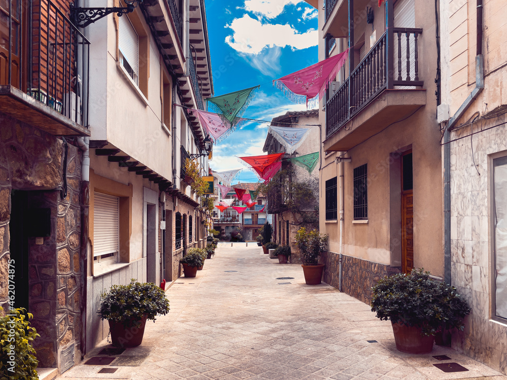Fototapeta premium Spanish village street in the province of Avila decorated with shawls. Copy space.