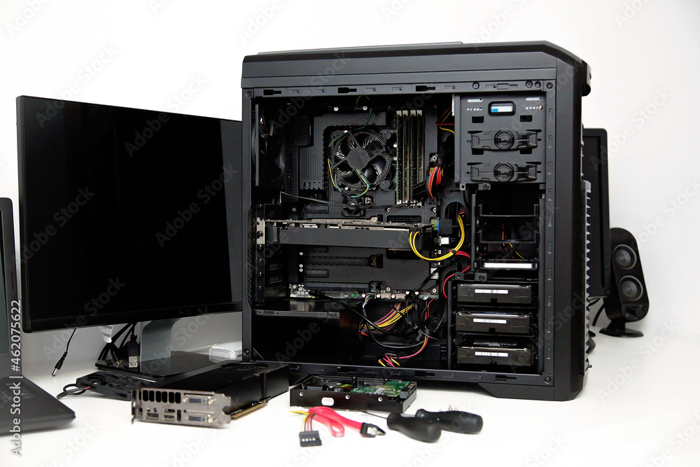 Fototapeta premium Building of PC, ATX motherboard and computer power supply unit inserted to black midi tower case