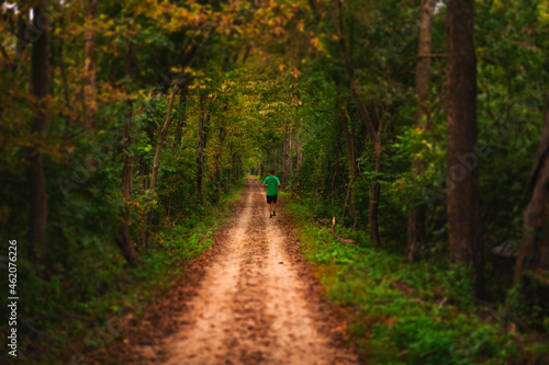 Man Running On Fall Autumn Forest Path In Woods