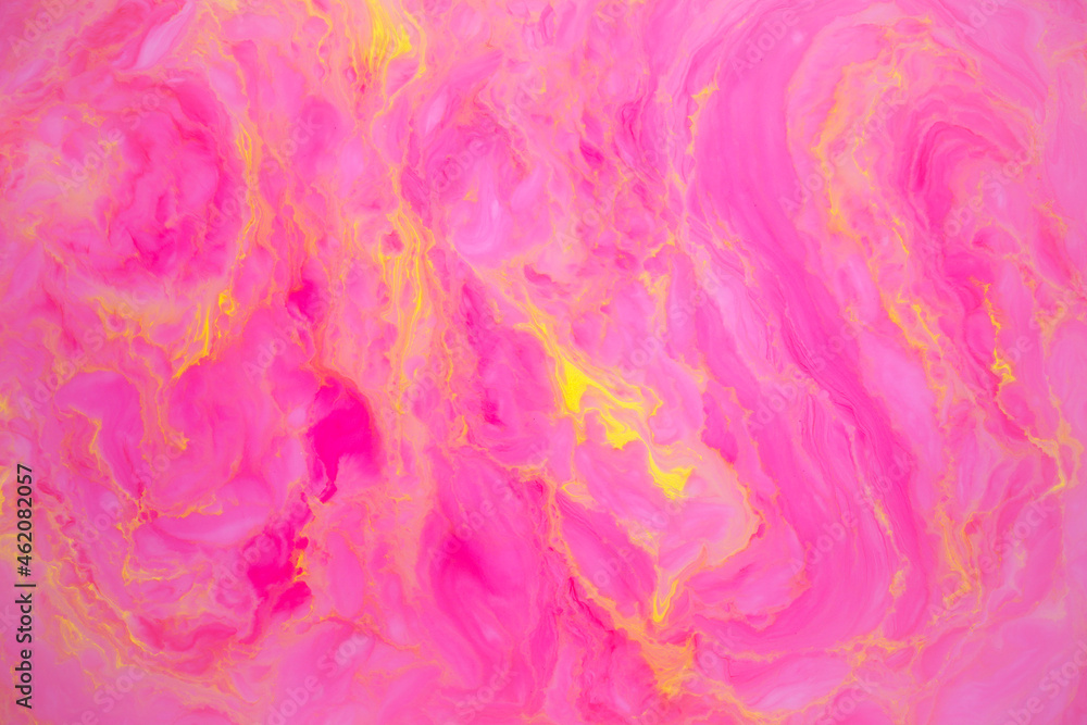Abstract colored marble background, stains of pink and yellow paint on the surface of the water. Liquid colorful backdrop.