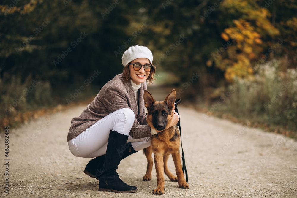 Beautiful woman walking out her dog in autumn park Beautiful woman walking out her dog in autumn park