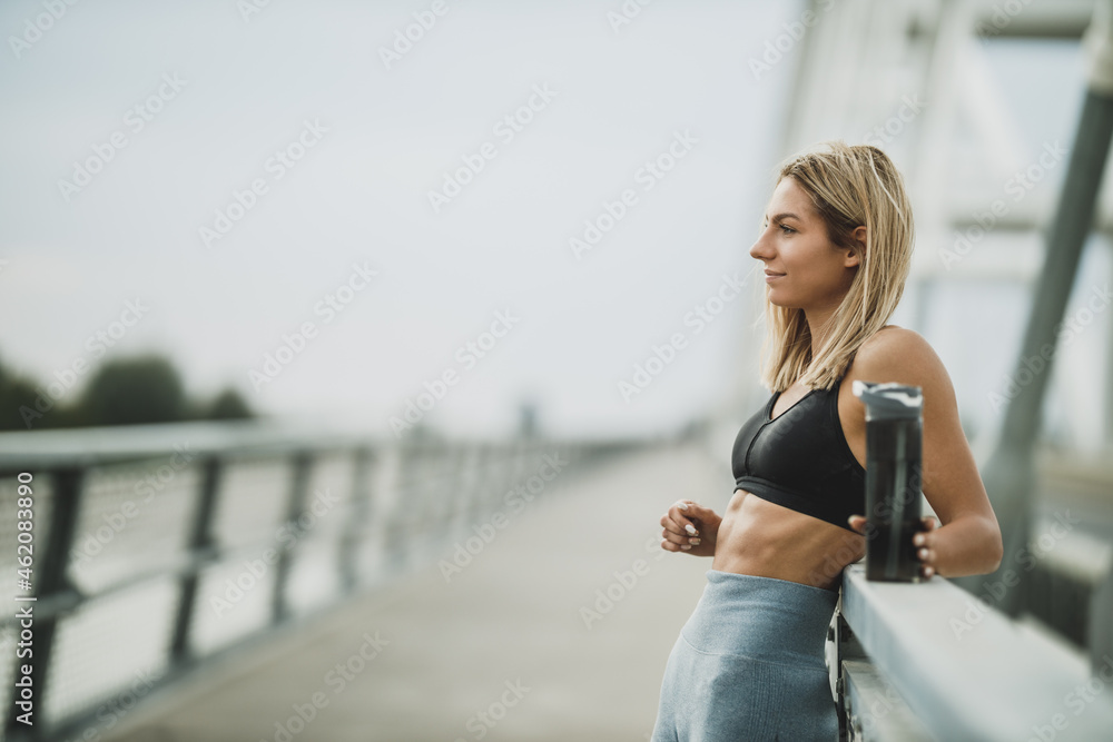 Woman Holding Water Bottle And Preparing For Outdoor Working Out - obrazy, fototapety, plakaty 