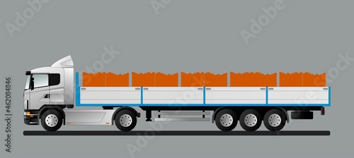 A car with a trailer for the delivery of new red clay bricks on pallets to the construction site.