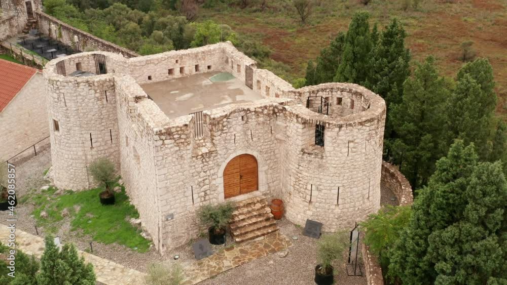 Old stone fortress Besac in Virpazar Montenegro. Aerial view of medieval castle on top of the hill surrounded by green trees as historical fortification and cultural heritage. Old stone fortress Besac in Virpazar Montenegro. Aerial view of medieval castle on top of the hill surrounded by green trees as historical fortification and cultural heritage.