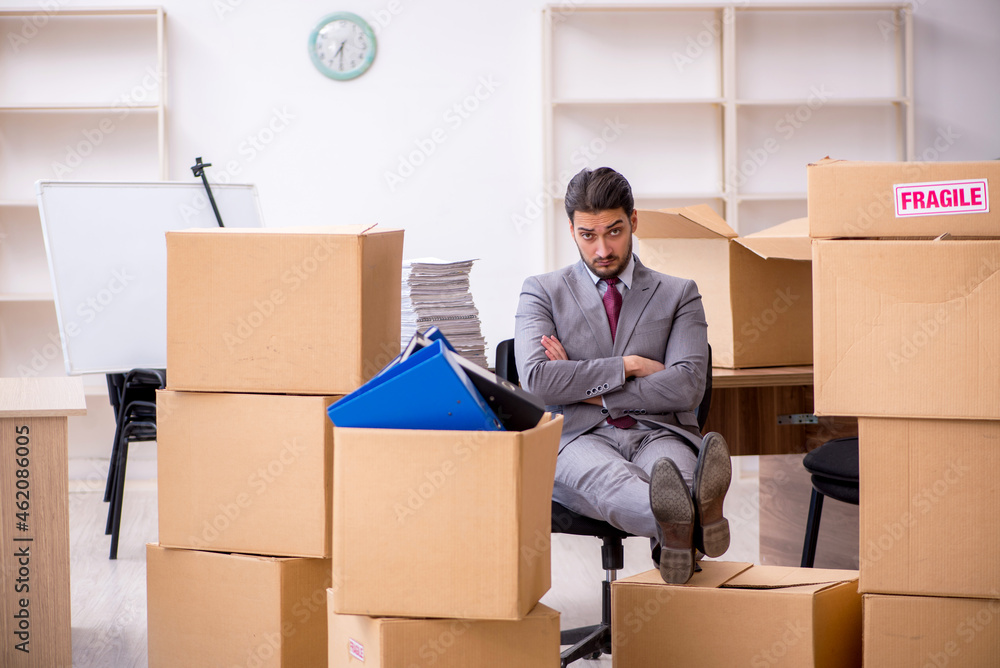 Young male employee in relocation concept Young male employee in relocation concept