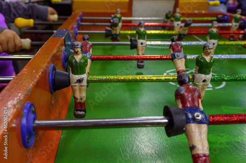 Cropped image of young people playing foosball