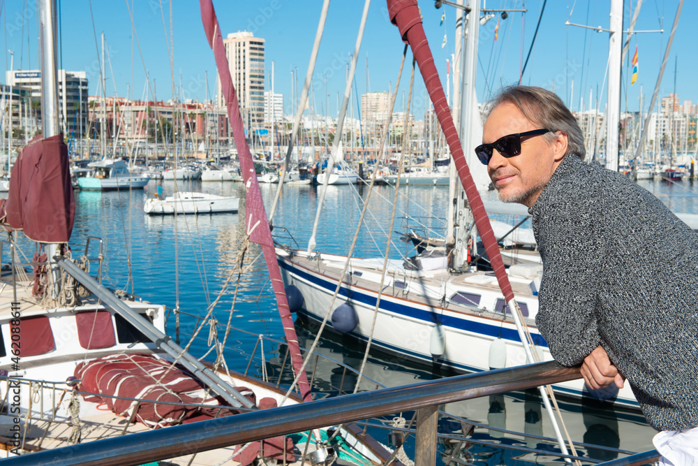 Attractive mature man in a marina in the city
