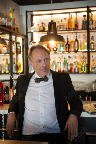 Attractive mature man with tuxedo in a pub