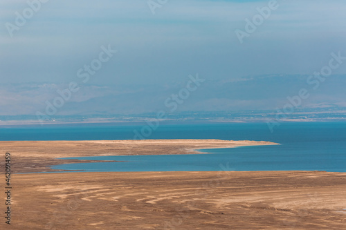 Panoramic view of the Dead Sea in Israel and Jordan on the other side. Blue water and Desert. Wild shore of the Dead Sea