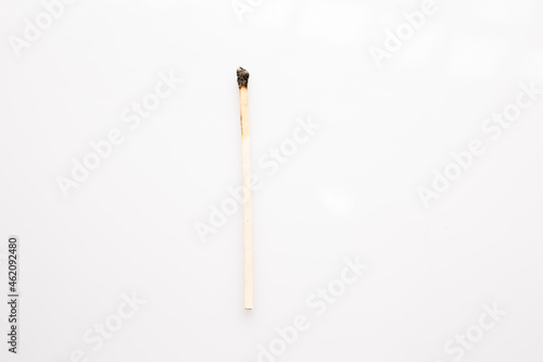 Burnt wooden matches upright on white background.