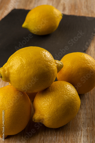 Lemons on slate plate and wooden background