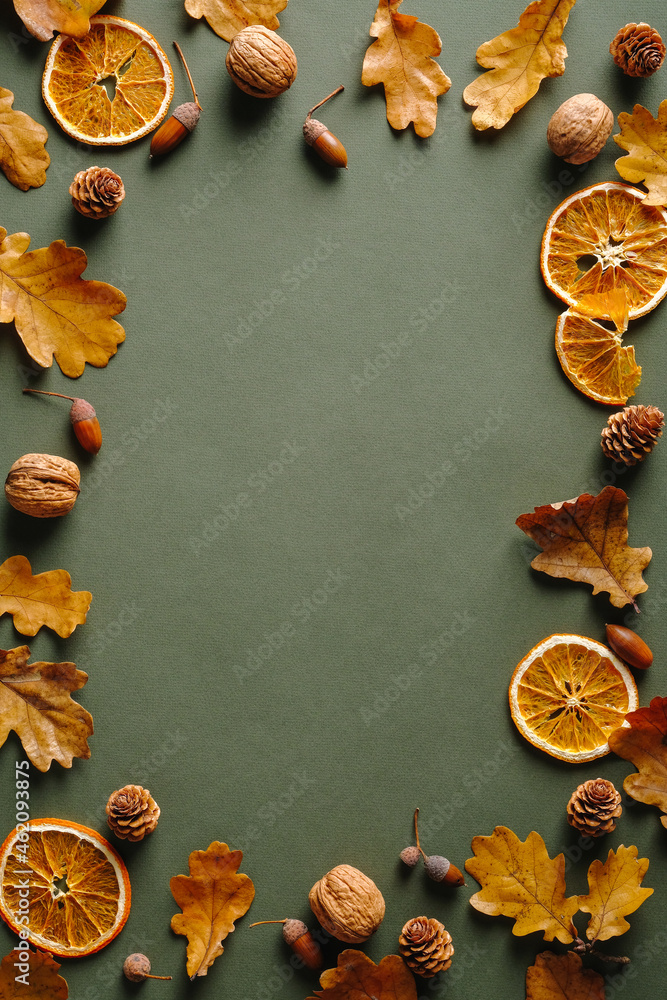 Frame made of oranges, dry oak leaves, nuts, acorns on vintgae green background. Autumn fall, Thanksgiving concept. Frame made of oranges, dry oak leaves, nuts, acorns on vintgae green background. Autumn fall, Thanksgiving concept.