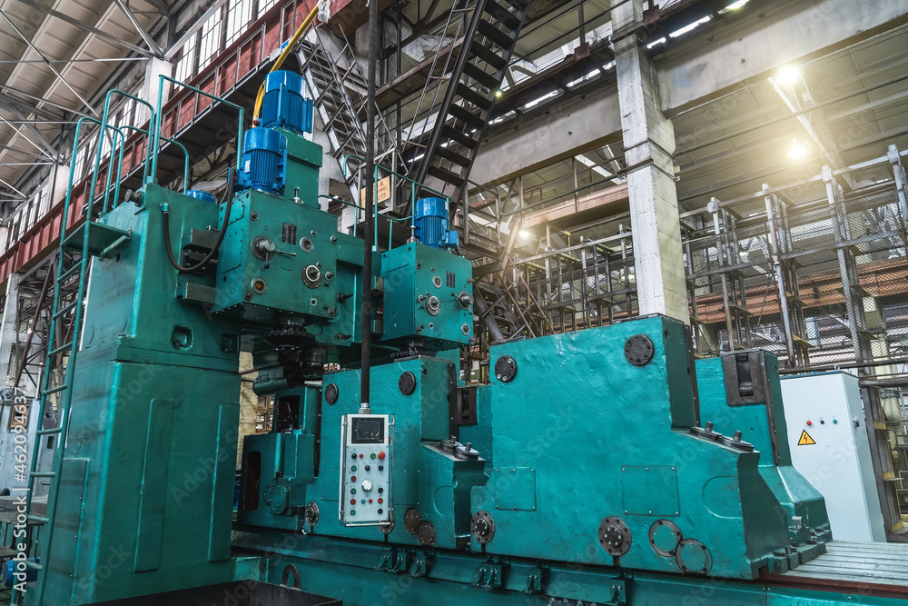 Automated lathe machine in factory workshop, boring of part with milling tool. Metalworking machine grinds tube metal product. Automated lathe machine in factory workshop, boring of part with milling tool. Metalworking machine grinds tube metal product.
