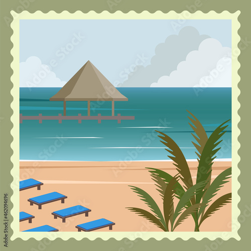 Beach in the Maldives with palm trees, bungalows and sun loungers