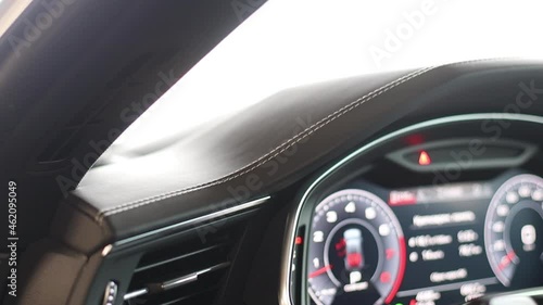 Air deflector, air conditioner in the car. Dashboard stitching and airbag lettering. Electric dashboard and virtual cockpit photo